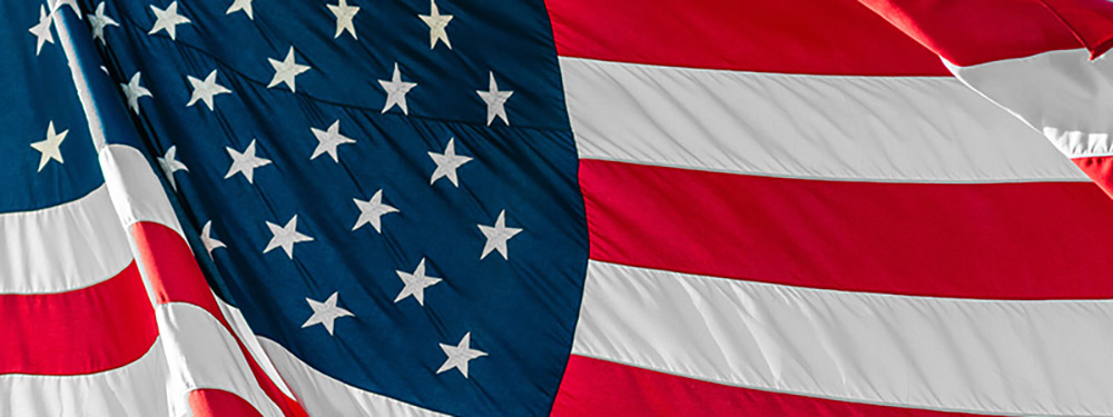 dark blue image of a waving American flag